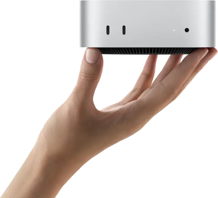 Mac Mini M4 sostenido en una mano, recortado con fondo transparente